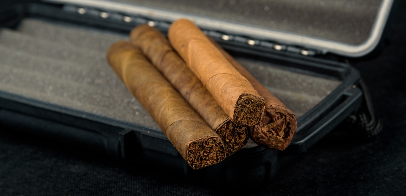 cigars on top of a black travel humidor